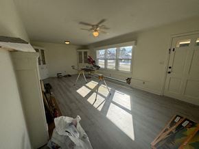 Mount Airy house for rent - A room with a ceiling fan and a window with sunlight coming through.