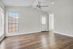 Beaumont apartment for rent - A room with a ceiling fan and wooden flooring.