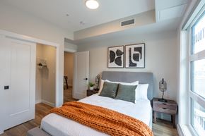 Edmonton apartment for rent - A bedroom with a large bed and a window.