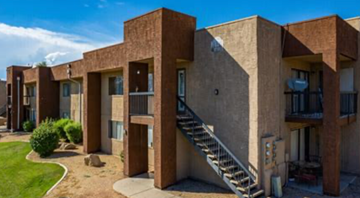 Phoenix apartment for rent - A series of brown concrete buildings with staircases leading to the second floor.