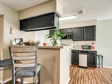Mesquite apartment for rent - A kitchen with a wooden chair and a counter.