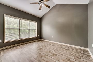 Dallas apartment for rent - A modern kitchen with a stainless steel refrigerator and white cabinets.