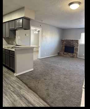 Dallas apartment for rent - A living room with a fireplace and a window.