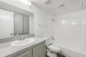 Fort Worth apartment for rent - A dining room with a table set for two and a ceiling fan.