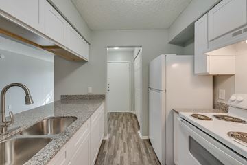 Irving apartment for rent - A kitchen with white cabinets and a stainless steel sink.