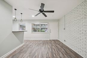 Dallas apartment for rent - A bedroom with a bed, nightstand, and a ceiling fan.