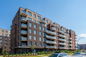 Saint-Laurent apartment for rent - A large apartment building with balconies and multiple stories.