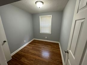 Washington apartment for rent - A room with a wooden floor and a window with blinds.