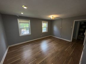 Washington apartment for rent - A room with wooden floors and two windows.