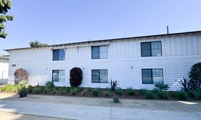 Torrance apartment for rent - A white building with a blue sky in the background.