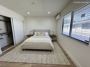 Torrance apartment for rent - A bedroom with a large bed and a rug on the floor.