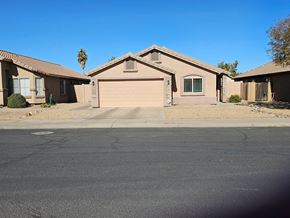 Glendale house for rent - A house with a garage is situated in front of a palm tree.