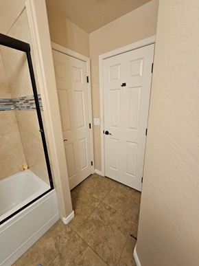 Glendale house for rent - A bathroom with a tub and two doors.