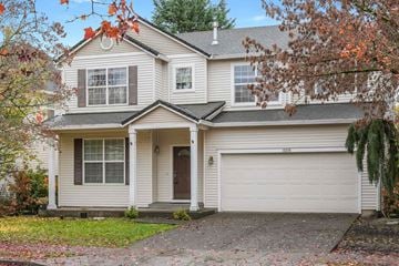 Beaverton house for rent - A two-story house with a white garage door and a brown roof.