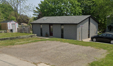 New Dundee house for rent - A small grey building with a black car parked in front.