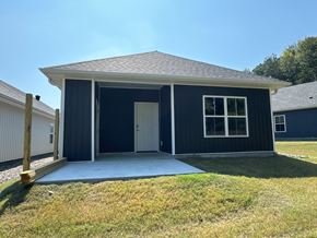 Little Rock house for rent - A small house with a dark blue exterior and a white door.