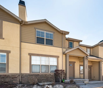 Herriman house for rent - A beige house with a brown door and a small front yard.