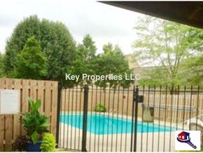 Knoxville house for rent - A pool surrounded by a fence with a sign that says Key Properties LLC.