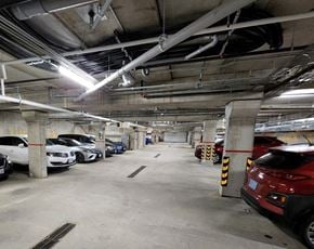 Pembroke apartment for rent - A parking garage with cars parked in it.