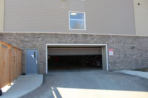 Pembroke apartment for rent - A garage door is open and a sign is on the wall.
