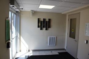Pembroke apartment for rent - A hallway with a black mat on the floor and a door on the right.