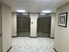 Pembroke apartment for rent - Three elevators in a hallway with a framed picture on the wall.