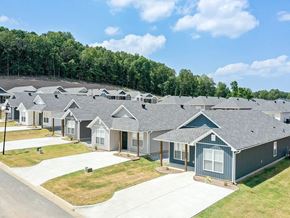Little Rock house for rent - A row of houses with grey roofs and white windows.