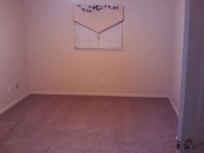 Crystal River house for rent - A room with a carpet and a picture hanging on the wall.