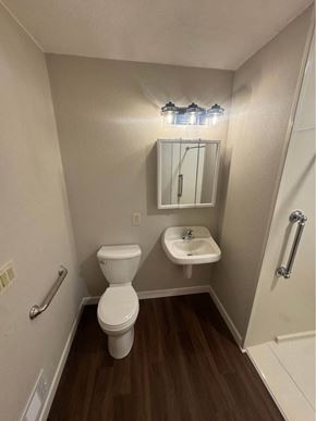 Rothschild house for rent - A small bathroom with a toilet, sink and mirror.