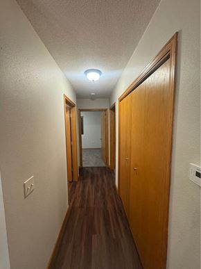 Rothschild house for rent - A long hallway with wood floors and white walls.