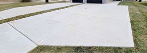 Warrensburg house for rent - A white concrete walkway leads to a building.