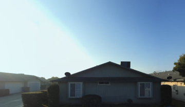 Exeter apartment for rent - A house with a white roof and a chimney is shown.
