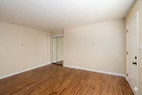 Sacramento apartment for rent - A room with wooden floors and white walls.