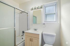 Sacramento apartment for rent - A white toilet sits next to a sink in a small bathroom.