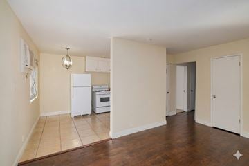Sacramento apartment for rent - A kitchen with white appliances and a wooden floor.