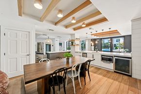 Pompano Beach apartment for rent - A modern kitchen with a wooden table and chairs.