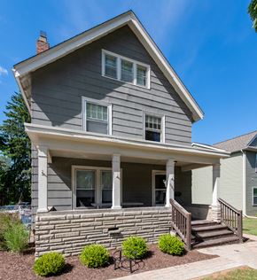 Ann Arbor apartment for rent - A house with a grey siding and a white porch.
