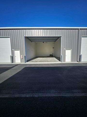 Boise apartment for rent - A large industrial building with a wide open garage door.