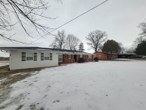 Lebanon house for rent - A white building with a red roof is surrounded by snow.