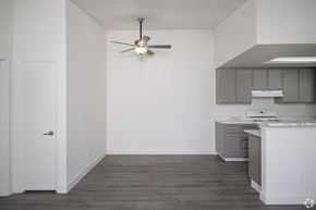 El Cajon apartment for rent - A white kitchen with a ceiling fan and a white door.