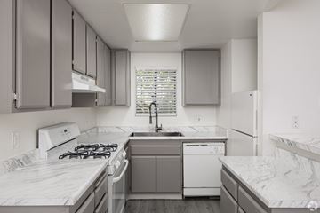 El Cajon apartment for rent - A kitchen with a white stove top oven and a white dishwasher.