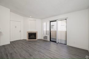 El Cajon apartment for rent - A spacious living room with a fireplace and sliding glass doors.