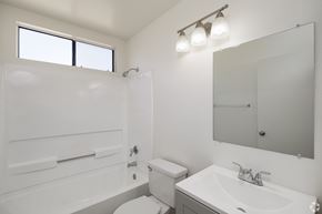 El Cajon apartment for rent - A white bathroom with a toilet, sink, and bathtub.