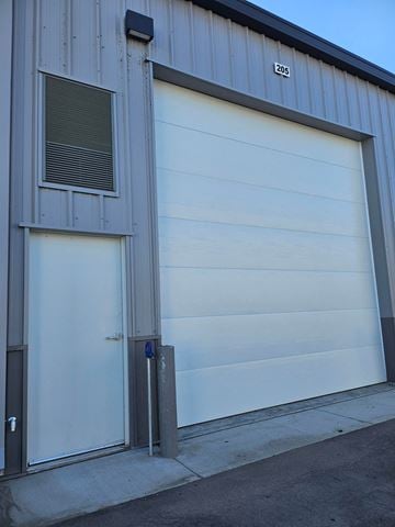 Boise apartment for rent - A garage door with the number 205 on the side of the building.
