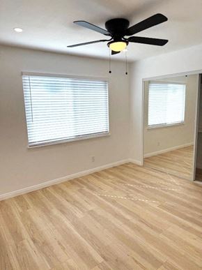 San Diego house for rent - A room with a ceiling fan and wooden flooring.