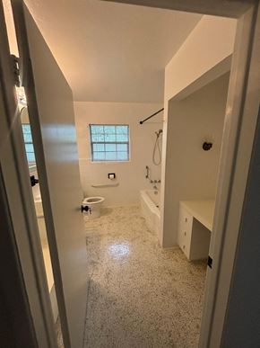 Lakeland apartment for rent - A bathroom with a toilet, sink, and window.