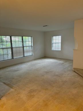 Lakeland apartment for rent - A large empty room with a window and a door on the right side.