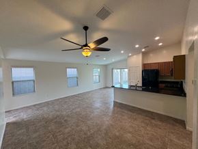 San Tan Valley house for rent - A spacious living room with a ceiling fan and a flat screen TV.