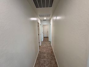 San Tan Valley house for rent - A long, narrow hallway with a carpeted floor and white walls.