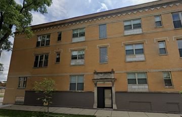 Chicago apartment for rent - A brown building with a tree in front of it.